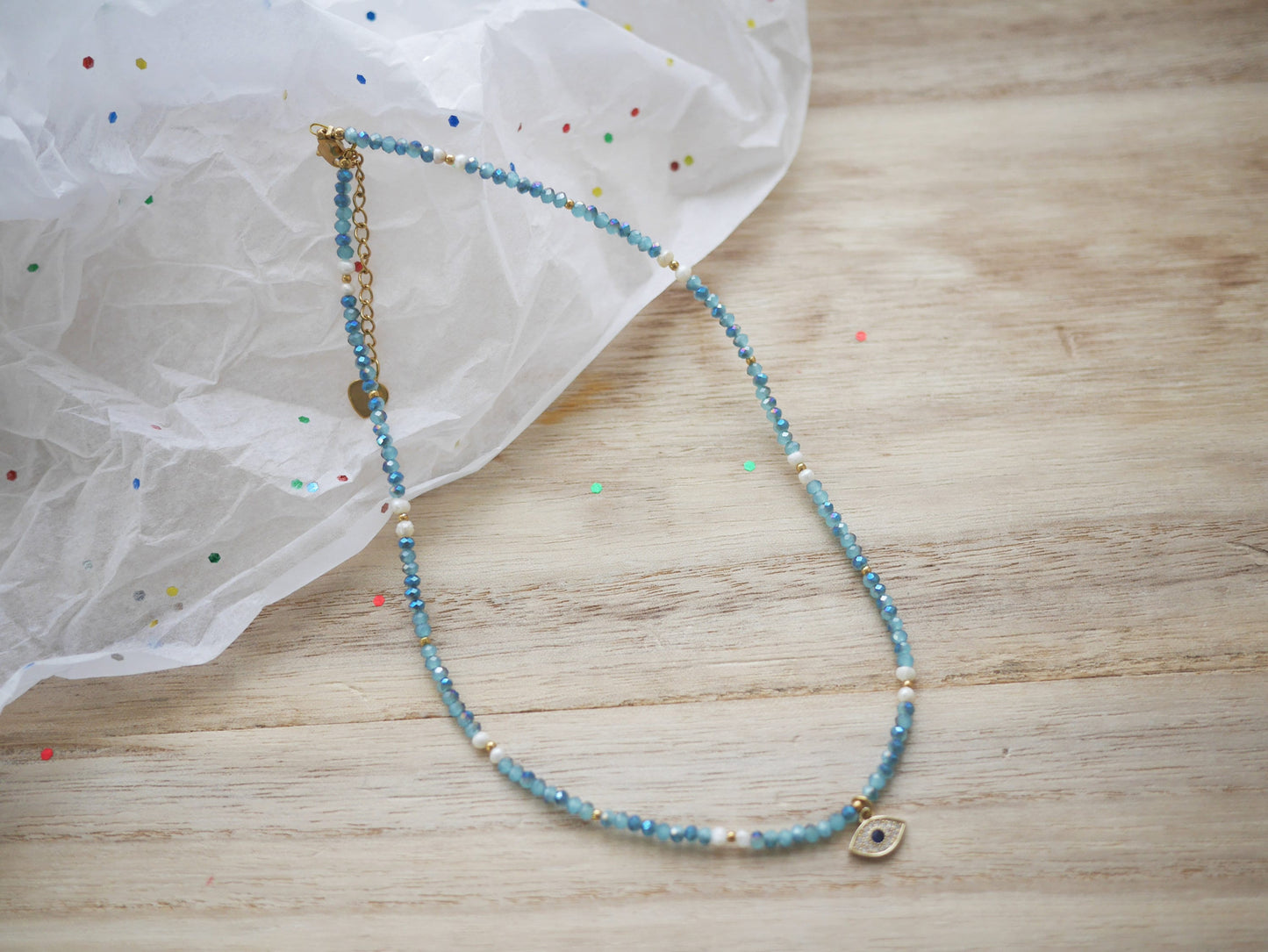 blue beaded necklace with evil eye charm